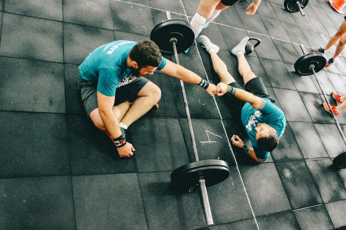 Two people training together on a gym floor